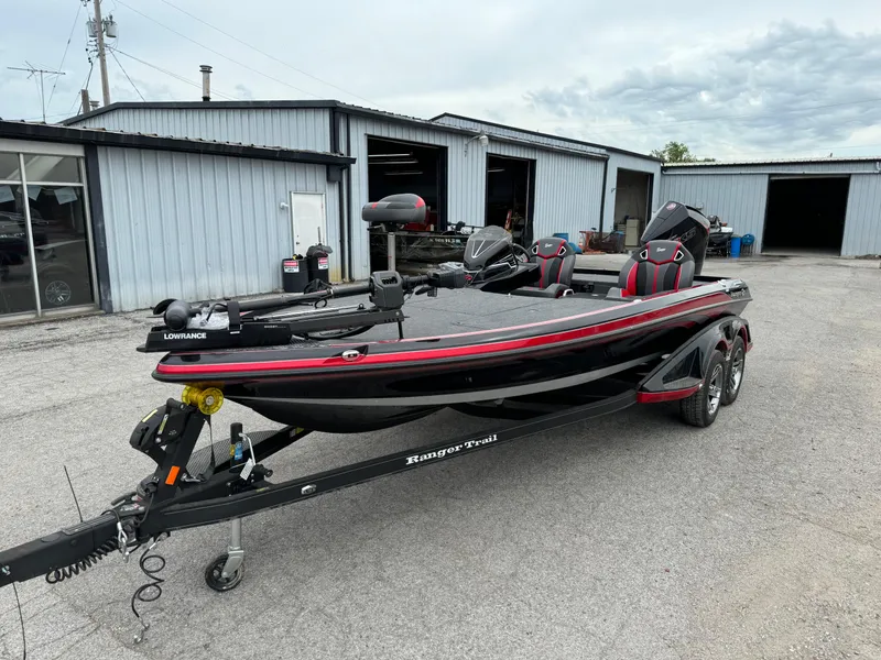 Slide: The Image of 2024 Ranger Z521R Ranger Cup Equipped boat on trailer, parked outside a garage. - 15