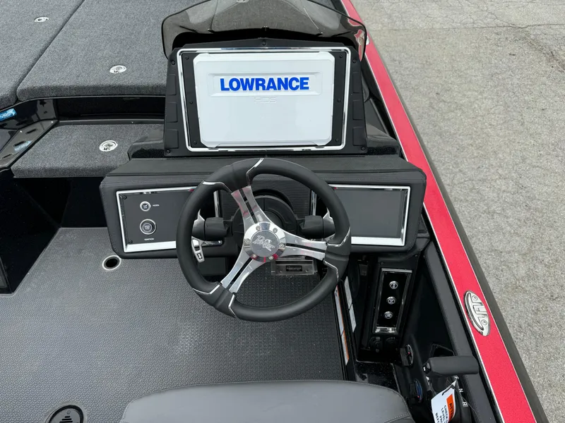 Slide: The Image of 2024 Ranger Z521R boat dashboard with Lowrance display and steering wheel. - 19