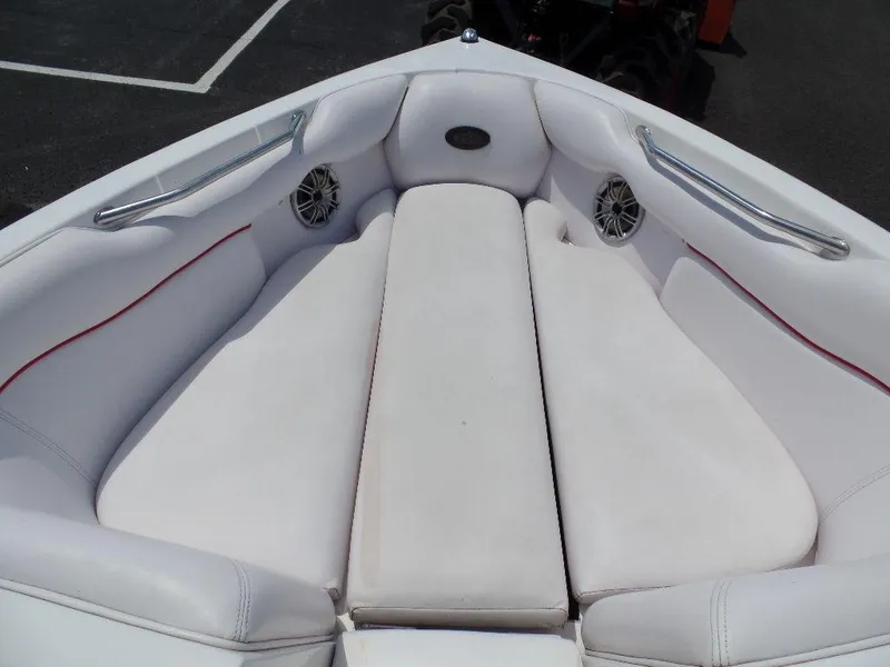 Slide: The Image of 2003 Supra 21 boat with white cushioned seating and built-in speakers. - 10