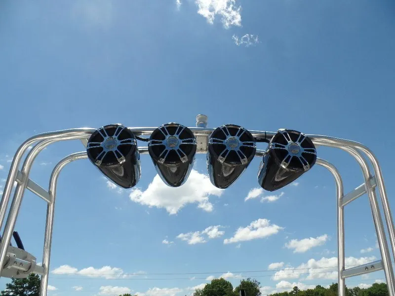 Slide: The Image of Speakers on a 2003 Supra 21 boat against a clear blue sky. - 14