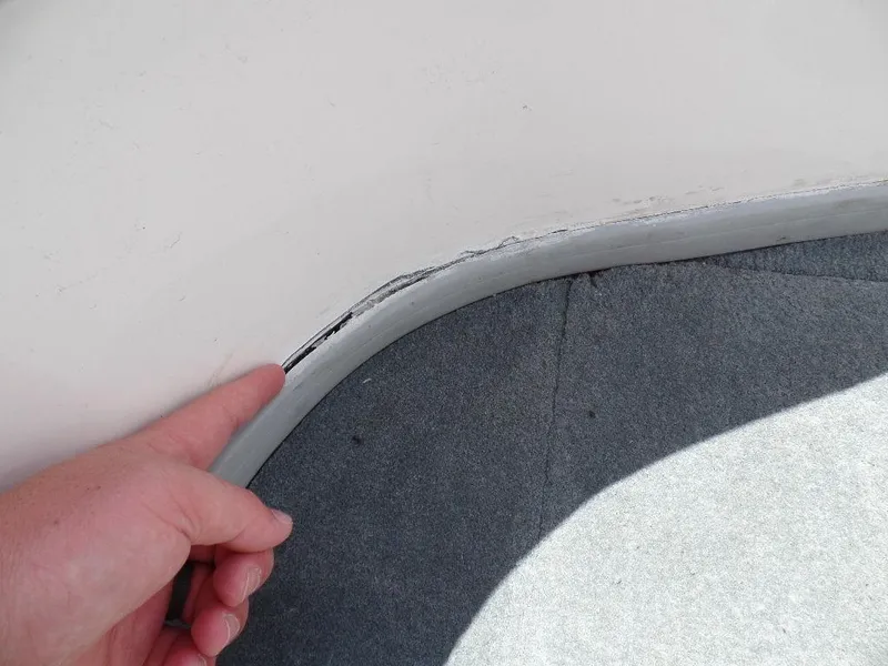Slide: The Image of Close-up of a cracked seal on a 2003 Supra 21 boat. - 15