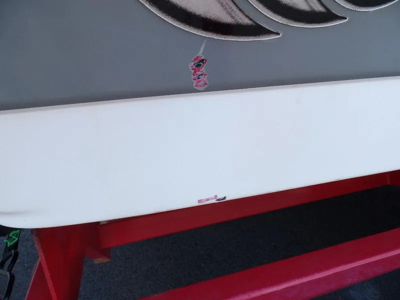 Slide: The Image of Close-up of a 2003 Supra 21 boat hull with minor scratches. - 16