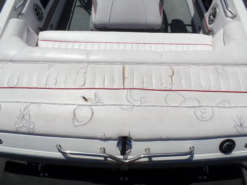 Slide: The Image of 2003 Supra 21 boat interior with white leather seats and red accents. - 4