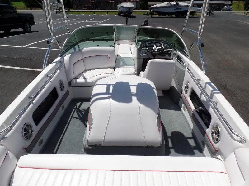 Slide: The Image of 2003 Supra 21 boat interior with white seating and modern dashboard. - 6