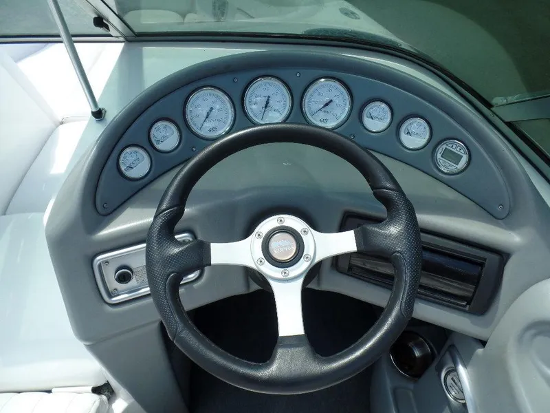 Slide: The Image of 2003 Supra 21 boat dashboard with steering wheel and gauges. - 9