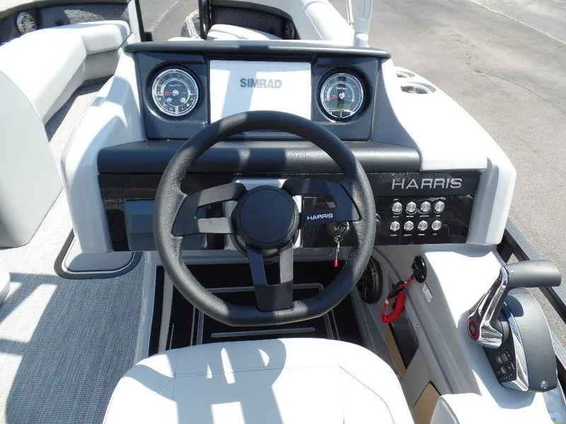 Slide: The Image of 2025 Harris Solstice 250 boat dashboard with steering wheel and control panel. - 10