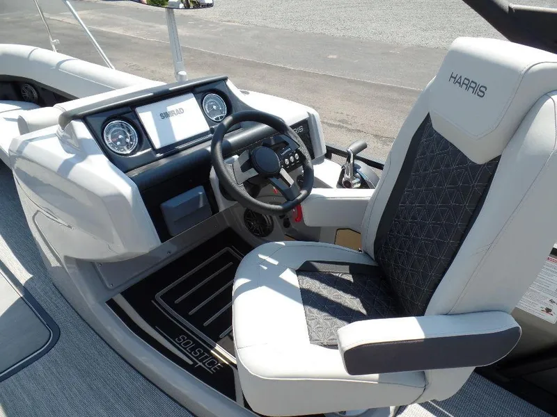 Slide: The Image of 2025 Harris Solstice 250 boat cockpit with steering wheel and control panel. - 11