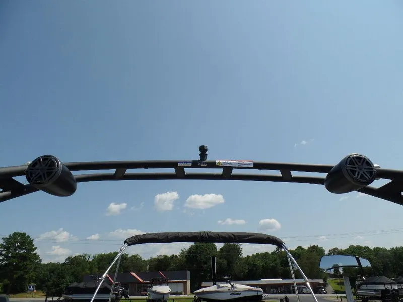 Slide: The Image of 2025 Harris Solstice 250 boat with speakers and canopy under a clear blue sky. - 17