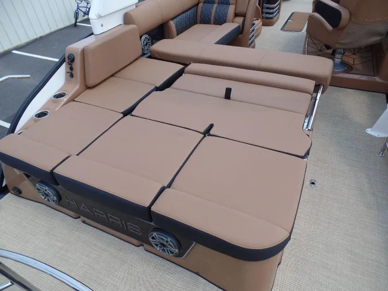 Slide: The Image of 2025 Harris Grand Mariner 250 boat with luxurious tan seating and integrated speakers. - 13