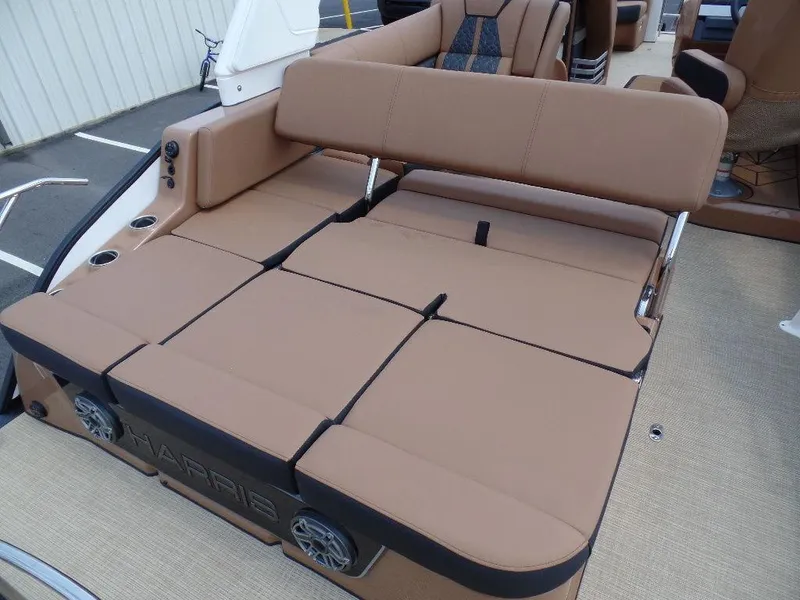 Slide: The Image of 2025 Harris Grand Mariner 250 boat with tan seating and integrated speakers. - 14