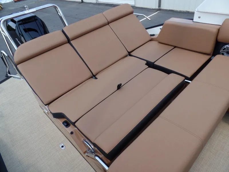 Slide: The Image of 2025 Harris Grand Mariner 250 boat with tan cushioned seating, sleek design. - 15