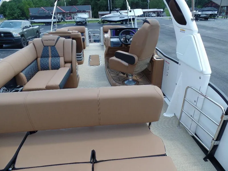 Slide: The Image of 2025 Harris Grand Mariner 250 boat interior with luxurious seating and modern helm. - 16