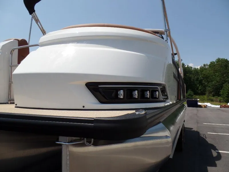 Slide: The Image of 2025 Harris Grand Mariner 250 pontoon boat, rear view, sleek design, outdoor setting. - 19