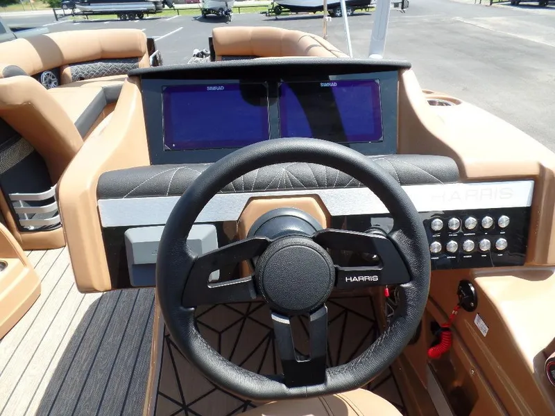 Slide: The Image of 2025 Harris Grand Mariner 250 dashboard with steering wheel and dual displays. - 11
