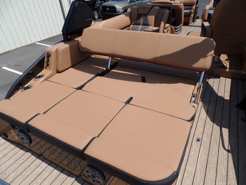 Slide: The Image of 2025 Harris Grand Mariner 250 boat with tan seating and spacious deck layout. - 13