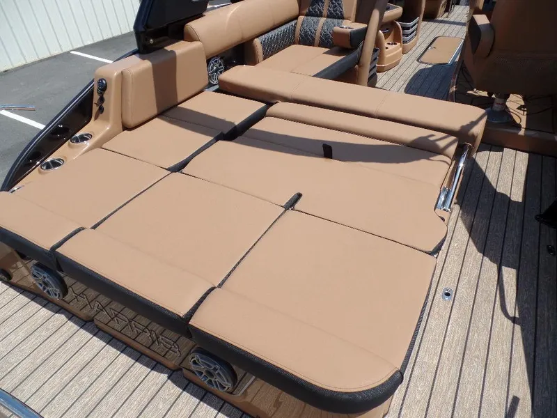 Slide: The Image of 2025 Harris Grand Mariner 250 boat with tan cushioned seating and wood-style flooring. - 14