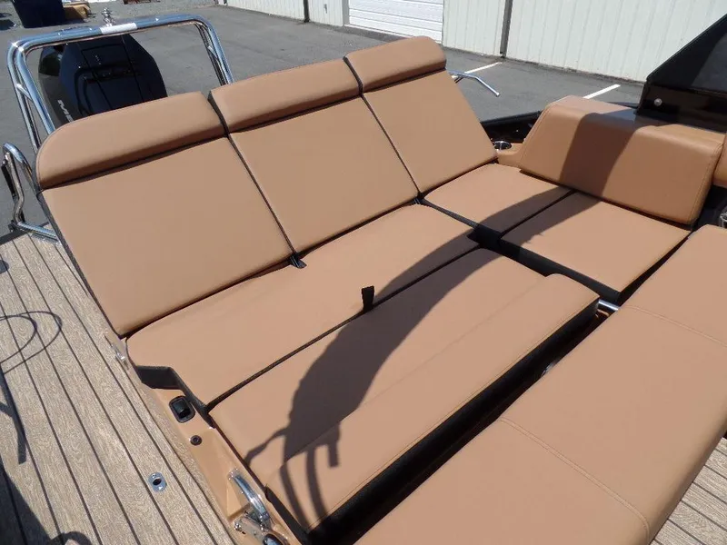 Slide: The Image of 2025 Harris Grand Mariner 250 boat with tan adjustable seating on deck. - 15