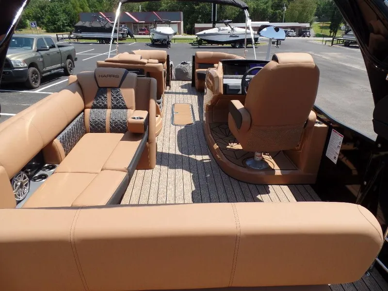 Slide: The Image of 2025 Harris Grand Mariner 250 boat interior with tan seating and modern design. - 17