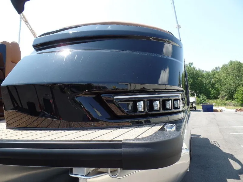 Slide: The Image of 2025 Harris Grand Mariner 250 boat, sleek black exterior, docked outdoors. - 19