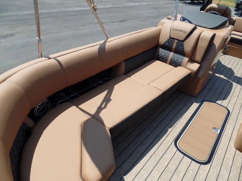 Slide: The Image of 2025 Harris Grand Mariner 250 boat interior with luxurious tan seating and wood flooring. - 6