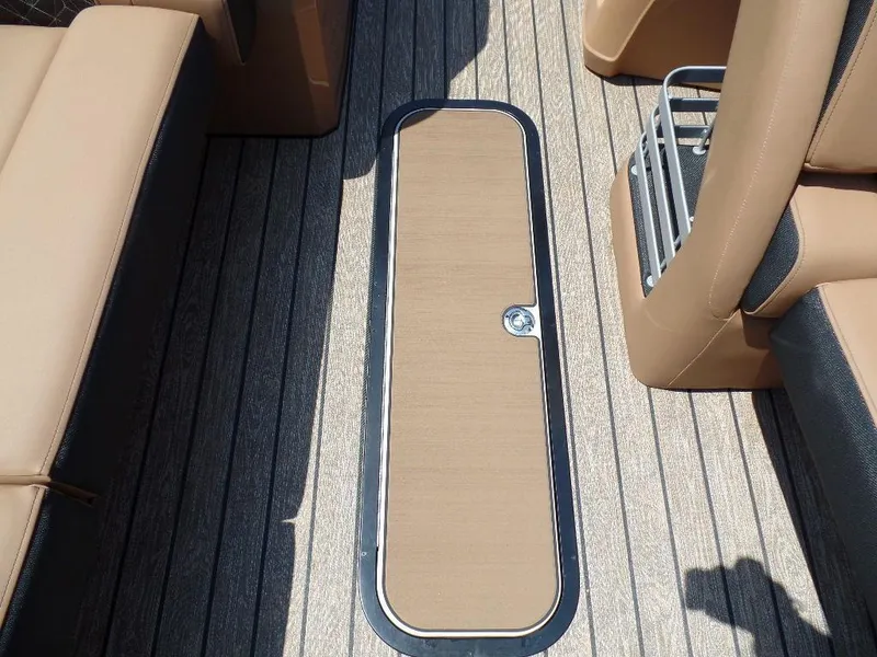Slide: The Image of 2025 Harris Grand Mariner 250 boat deck with tan seating and storage compartment. - 7