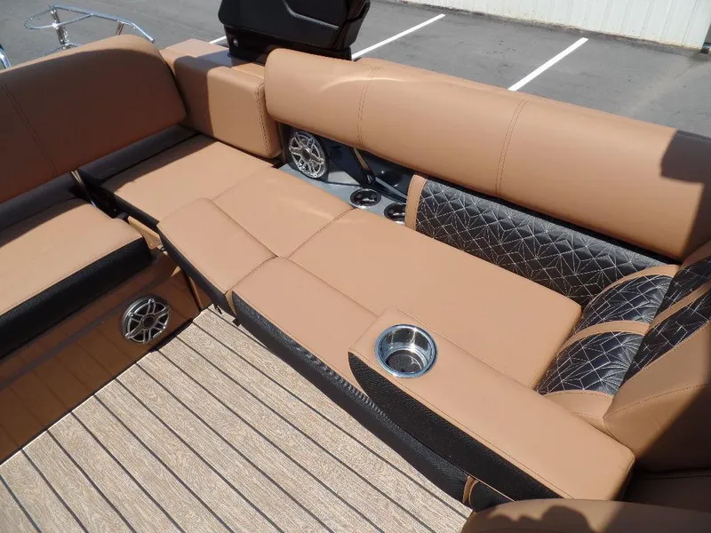 Slide: The Image of 2025 Harris Grand Mariner 250 interior with tan leather seating and cup holders. - 9