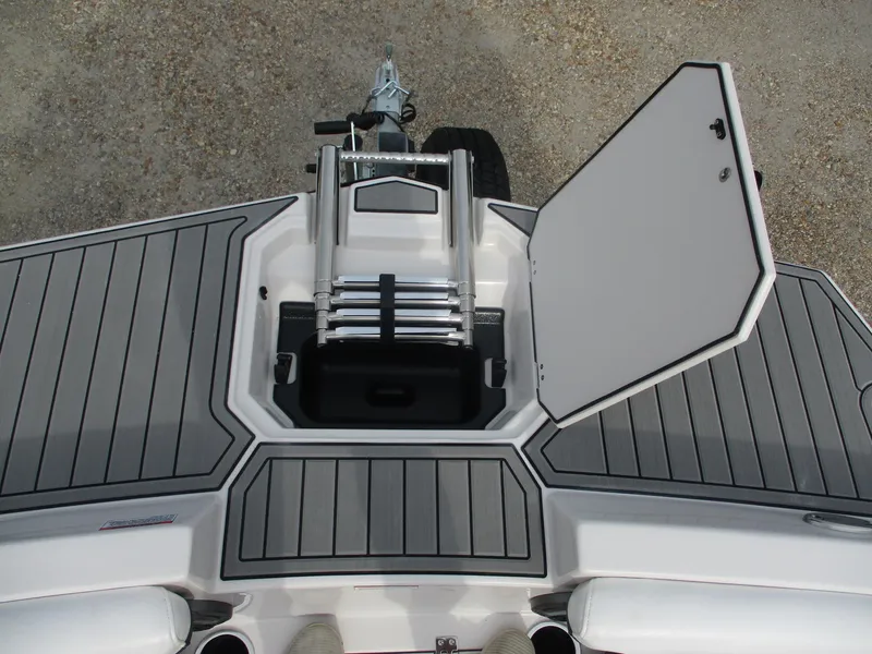 Slide: The Image of 2025 Starcraft SVX191 boat with open storage compartment and ladder. - 12