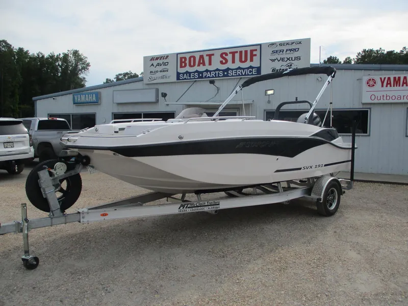 Slide: The Image of 2025 Starcraft SVX191 boat on a trailer at a dealership. - 2