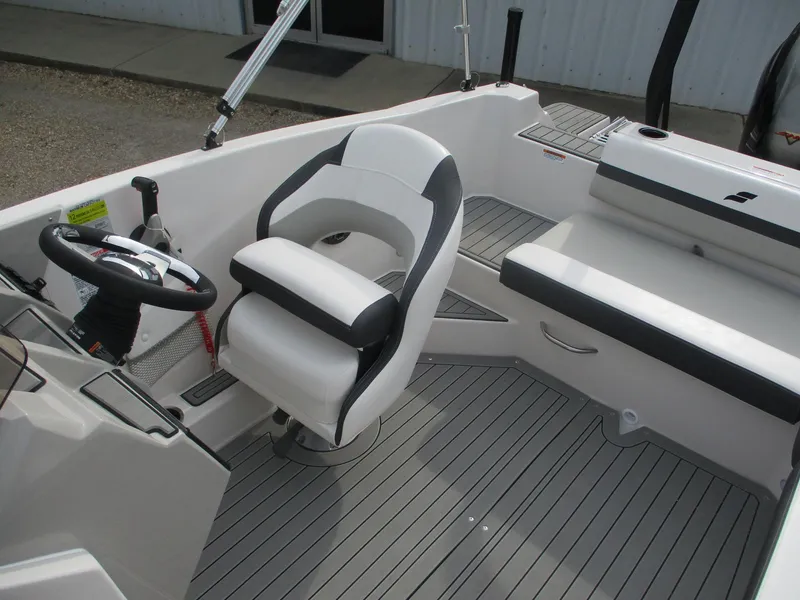 Slide: The Image of 2025 Starcraft SVX191 boat interior with captain's chair and seating area. - 7