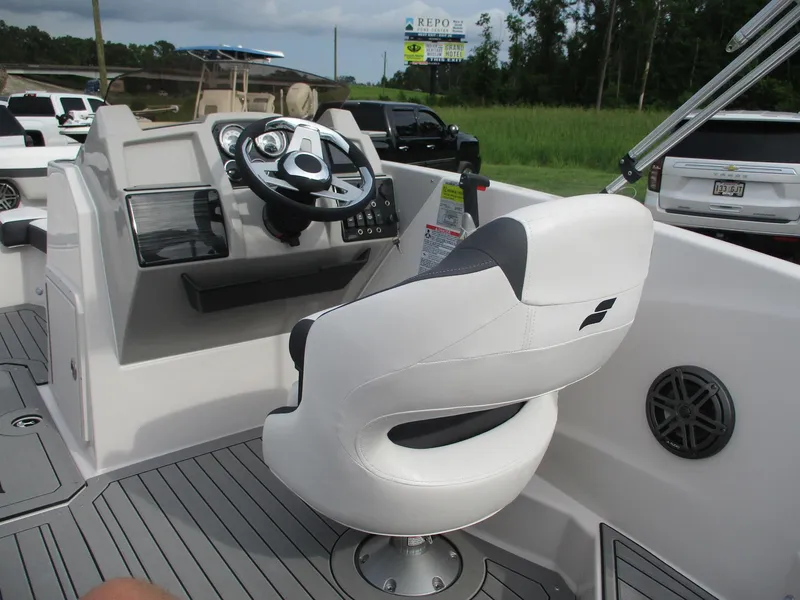 Slide: The Image of 2025 Starcraft SVX191 boat interior with captain's chair and steering console. - 8