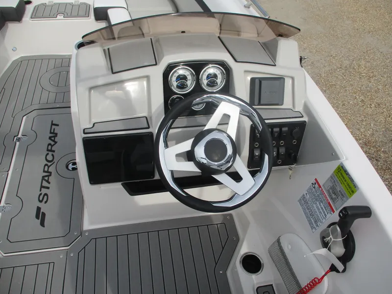 Slide: The Image of 2025 Starcraft SVX191 boat dashboard with steering wheel and control panel. - 9