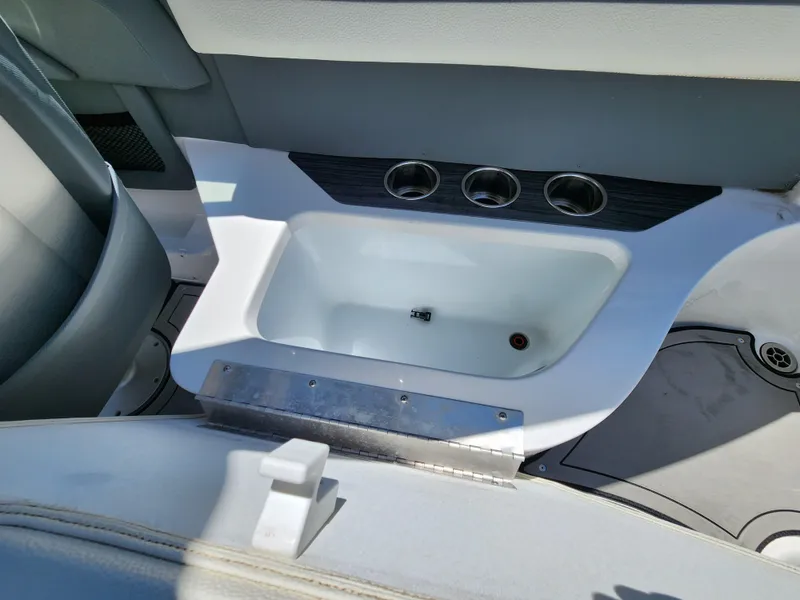 Slide: The Image of Cobalt R5 2020 boat interior with built-in cup holders and storage compartment. - 15