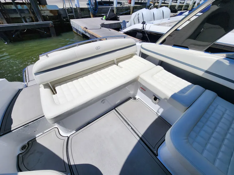 Slide: The Image of 2020 Cobalt R5 boat interior with white cushioned seating at the dock. - 6