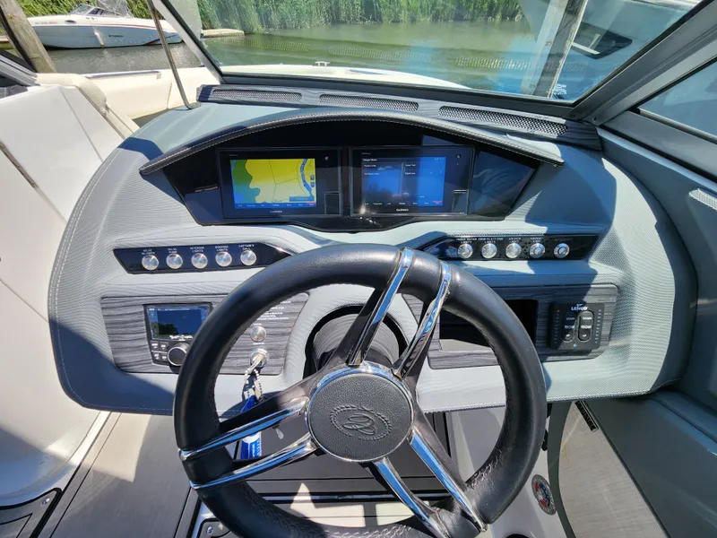 Slide: The Image of 2020 Cobalt R5 boat dashboard with steering wheel and navigation screens. - 9