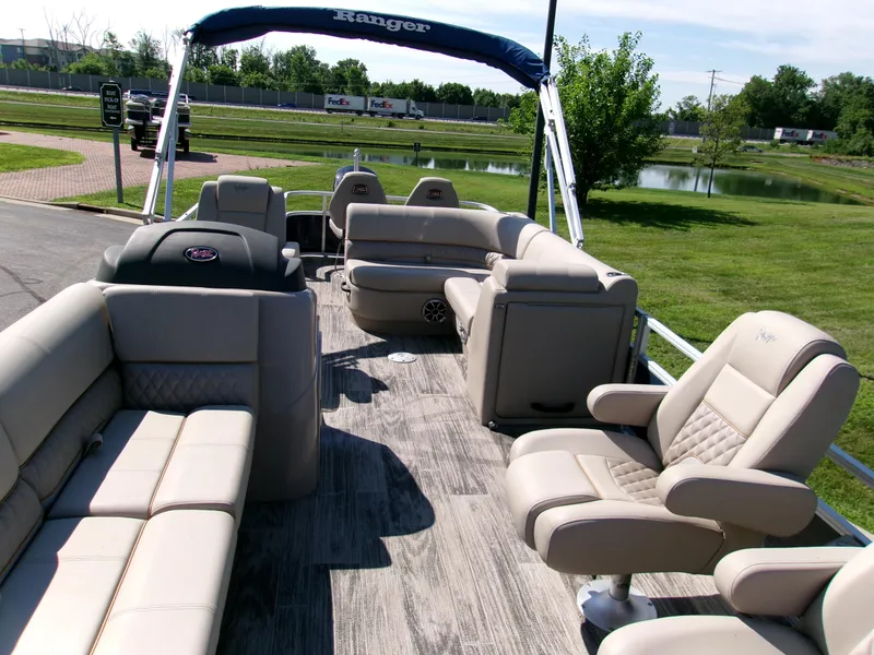 Slide: The Image of 2024 Ranger Reata 220FC pontoon boat interior with plush seating and modern design. - 3