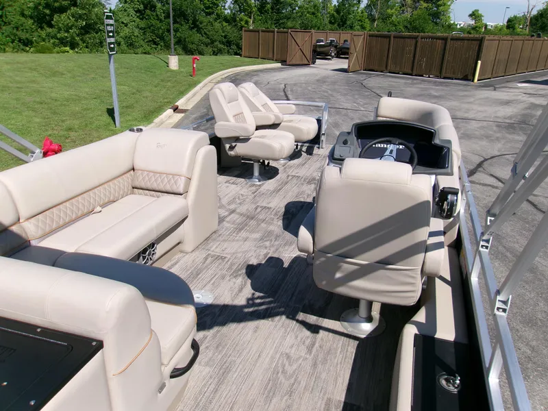 Slide: The Image of 2024 Ranger Reata 220FC boat interior with beige seating and modern helm. - 4