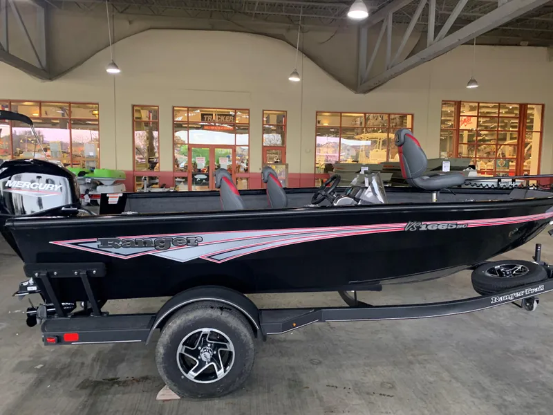The Image of 2024 Ranger VS1665SC boat in showroom, black with red accents, on trailer. - 0