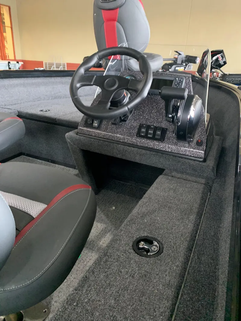 Slide: The Image of 2024 Ranger VS1665SC boat interior with steering wheel and seating. - 2