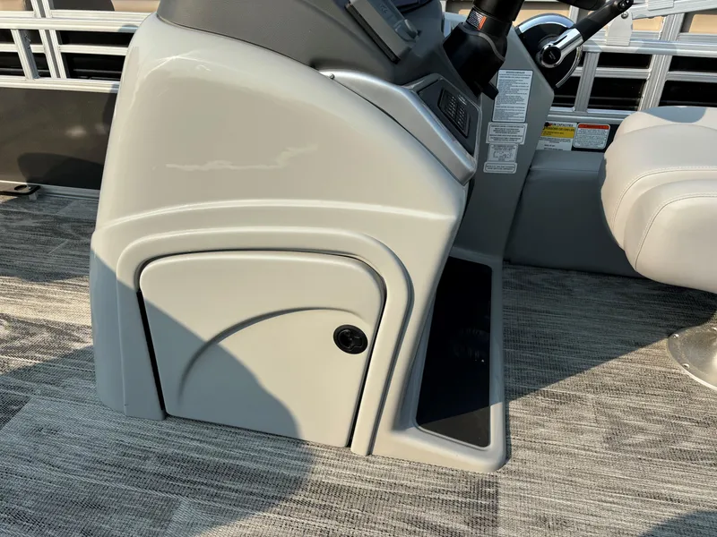Slide: The Image of 2024 Ranger Reata 220F boat console with storage compartment and steering wheel. - 10