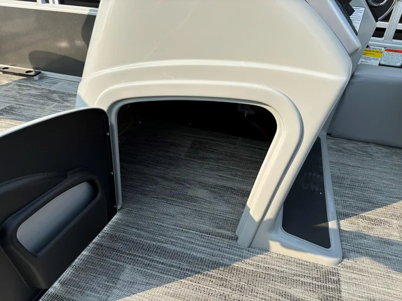 Slide: The Image of 2024 Ranger Reata 220F boat interior storage compartment with open door. - 11