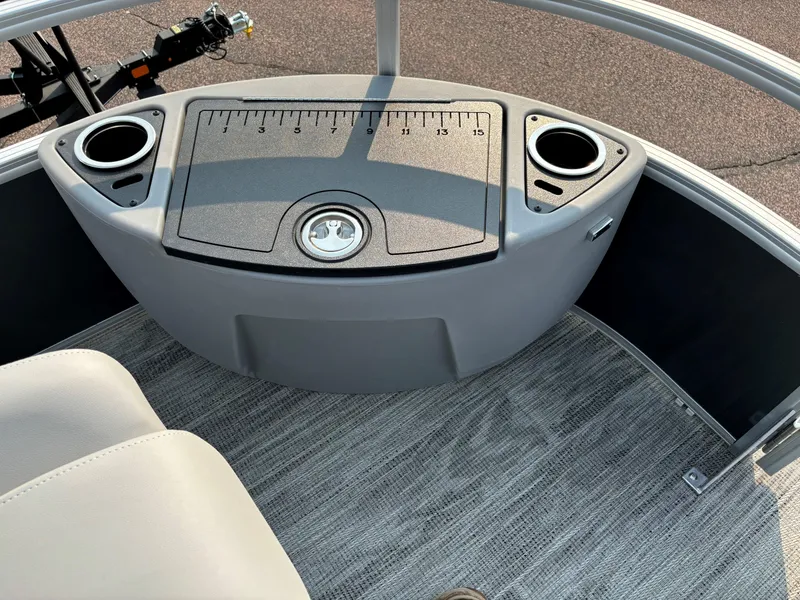 Slide: The Image of 2024 Ranger Reata 220F boat console with cup holders and measuring board. - 12