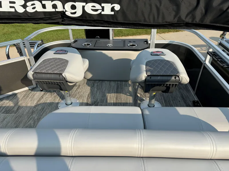 Slide: The Image of 2024 Ranger Reata 220F boat interior with cushioned seats and console. - 15