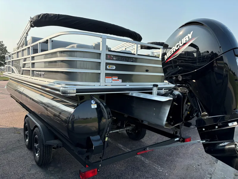Slide: The Image of 2024 Ranger Reata 220F pontoon boat with Mercury outboard motor on trailer. - 2