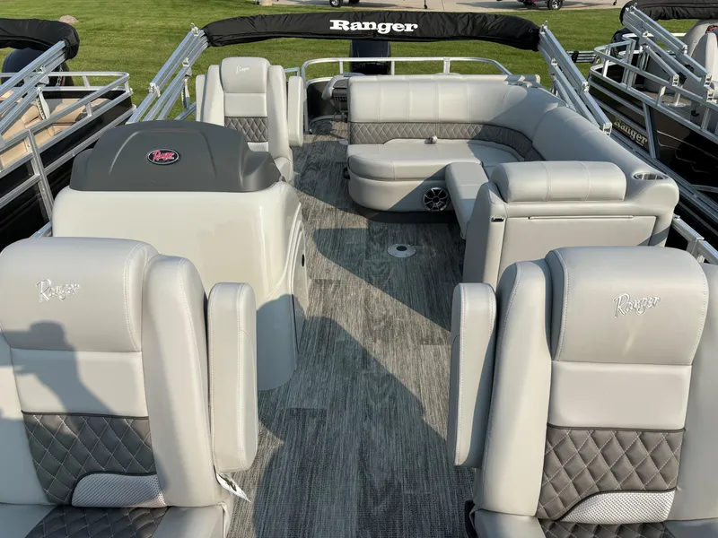 Slide: The Image of 2024 Ranger Reata 220F pontoon boat with luxurious seating and modern design. - 6