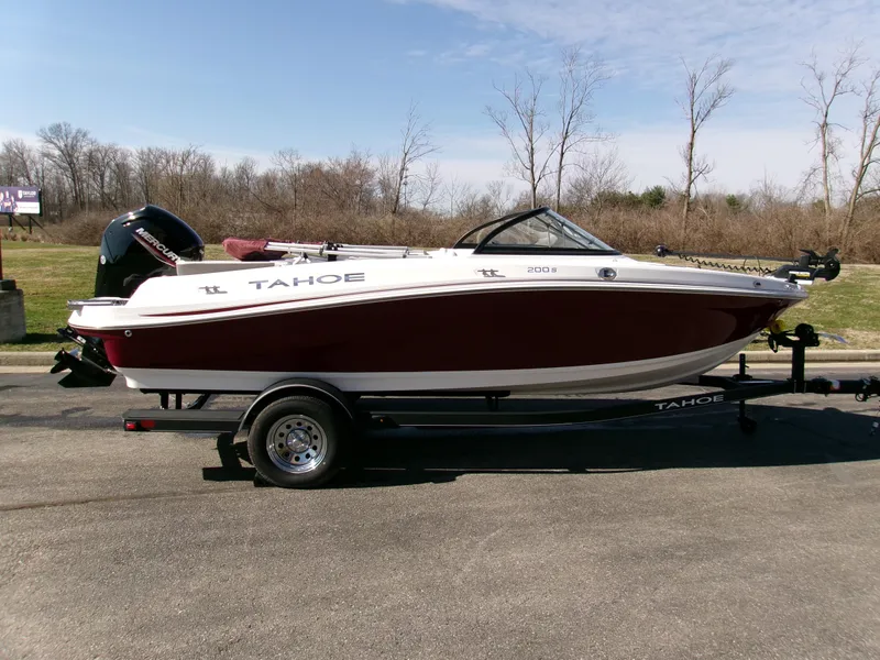 The Image of 2024 Tahoe 200 S boat on trailer, parked outdoors, side view. - 0