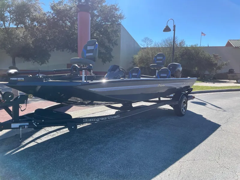 Slide: The Image of 2024 Ranger RT198P fishing boat parked outdoors on a sunny day. - 1