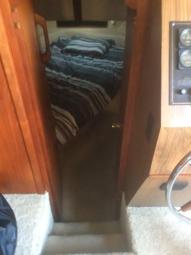 Slide: The Image of Interior view of 1985 Bluewater 42 Coastal Cruiser, showing cozy cabin with striped bedding. - 10