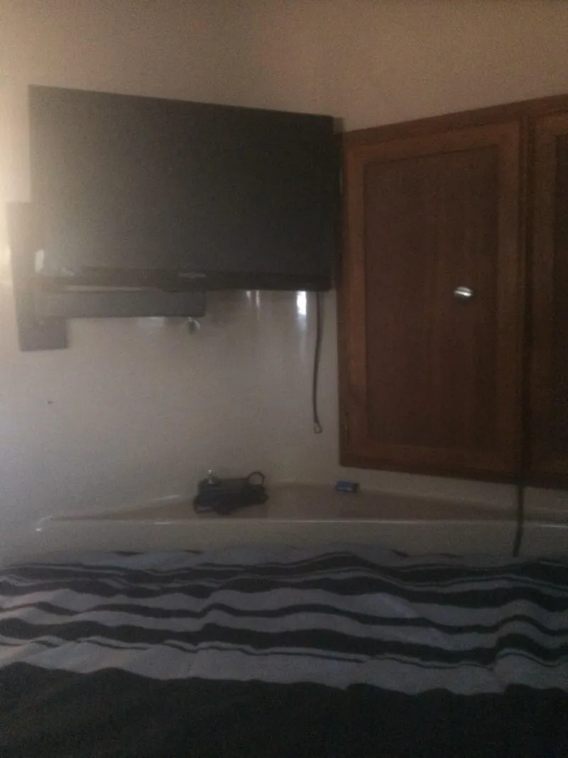 Slide: The Image of Interior of 1985 Bluewater 42 Coastal Cruiser with TV and wooden cabinets. - 12