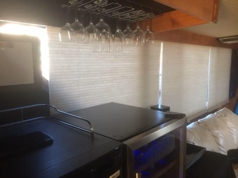 Slide: The Image of Interior of 1985 Bluewater 42 Coastal Cruiser with wine glasses and modern furnishings. - 16