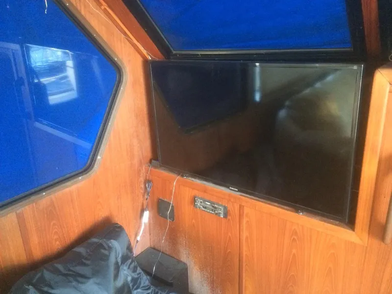 Slide: The Image of Interior of 1985 Bluewater 42 Coastal Cruiser with wood paneling and mounted TV. - 18